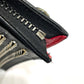 Christian Louboutin spiked studded Sky Pouch clutch bag in black leather.